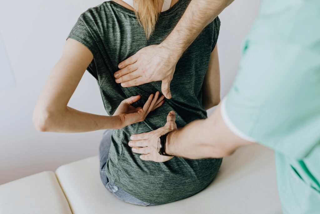 physical therapist helping a patient with back pain